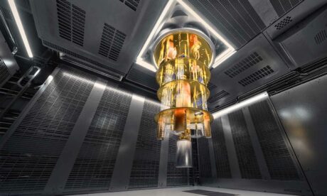 A featured image featuring a photograph of a quantum computer suspended from the ceiling inside a secure grey room